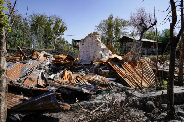 Piles of corrugated steal are all that remain of shops that were destroyed by the TPLF in the village of Libso during the 2021 TPLF occupation on January 12, 2022 in North Wollo, Ethiopia.