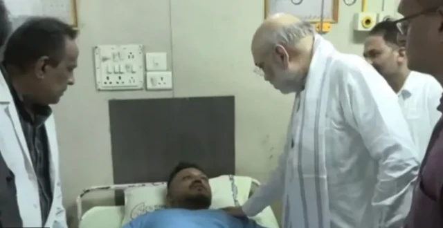 Hindistan İçişleri Bakanı Amit Shah, mucize yolcuyu hastanede ziyaret ediyor ve elini omzuna koymuş