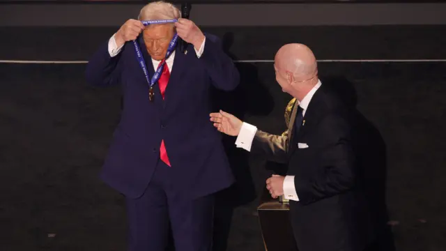 Donald Tramp, predsednik SAD, sam sebi stavlja FIFA medalju oko vrata