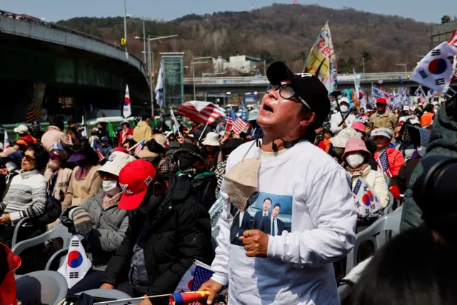 A far-right protester reacts after hearing that President Yoon Suk Yeol's impeachment was accepted, near his residence in Seoul, South Korea, April 4, 2025. REUTERS/Kim Soo-hyeon