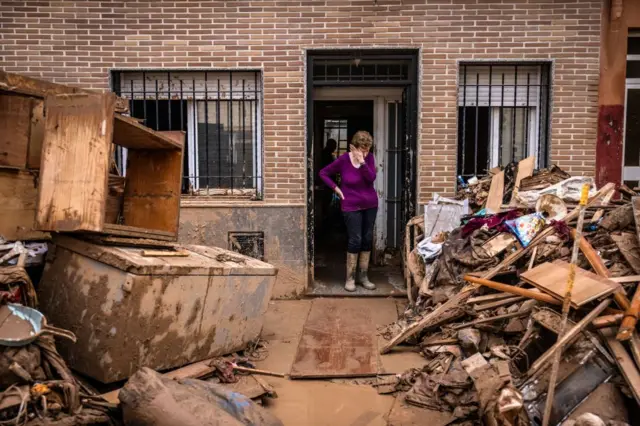 A resident looks at flood debris outside a home in Paiporta, Spain, on Sunday, Nov. 3, 2024. Bloomberg via Getty Images
