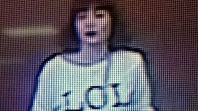 Grainy image shows a woman with brown hair wearing a T-shirt with the letters "LOL" emblazoned on it