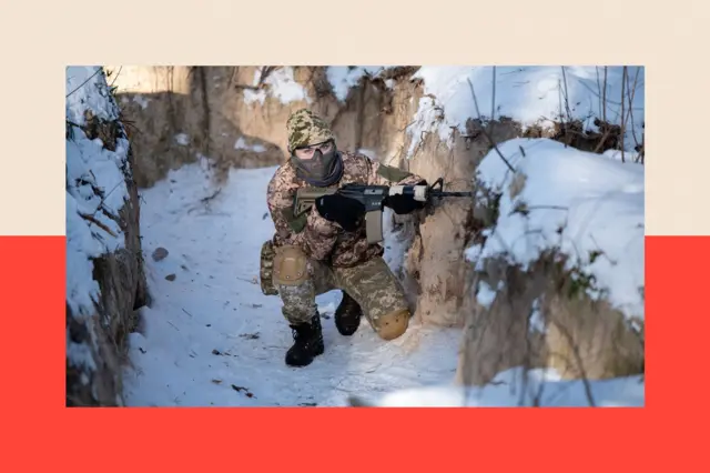 Військова з  гвинтівкою у засніженій траншеї