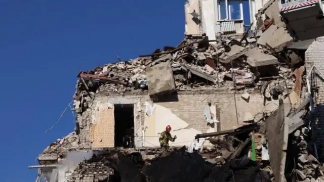Пожежник працює на руїнах знищеного будинку