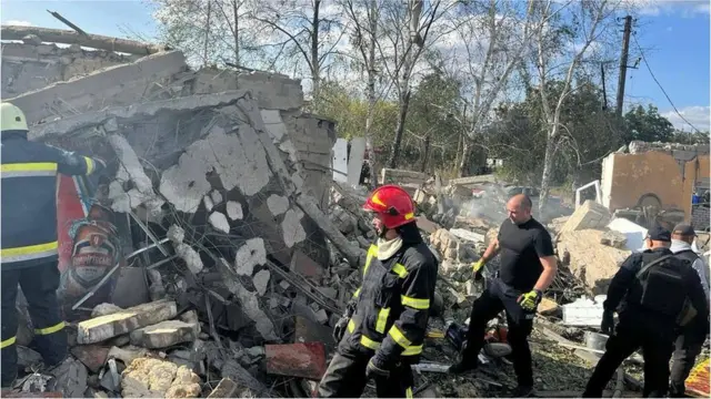 Rescuers comb through the bombed building