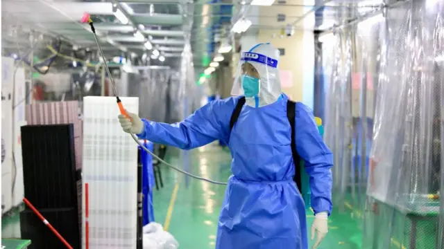 worker disinfects Foxconn plant, 6/11