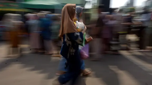 Warga membawa sembako saat pasar murah di Kodim 0736/Batang, Kabupaten Batang, Jawa Tengah, Selasa (05/03).