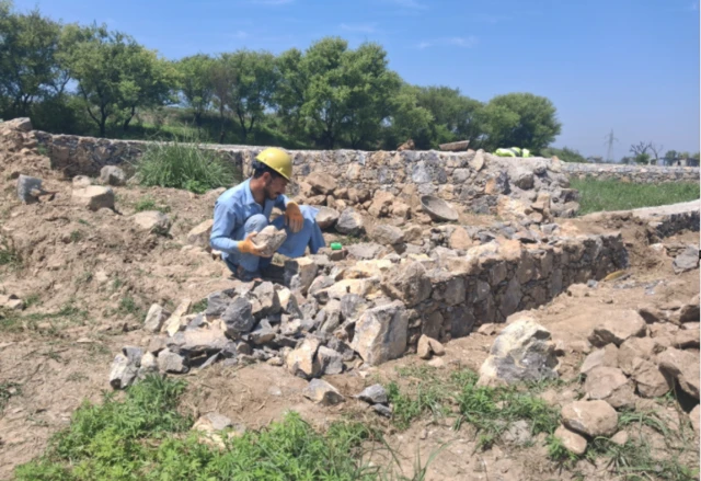 worker arranging stones 