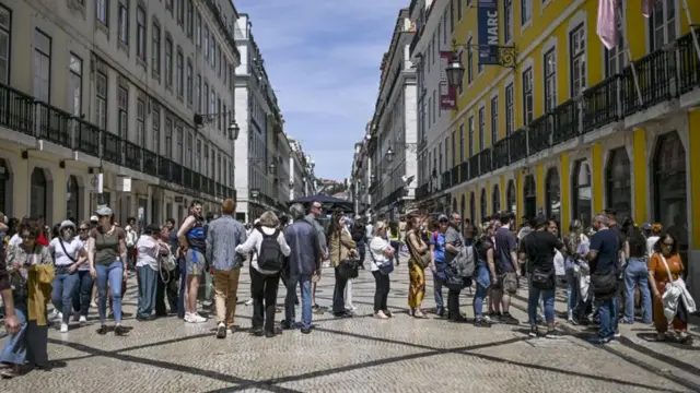 Saat pembayaran kartu dihentikan, orang-orang mengantre di mesin ATM di Lisbon
