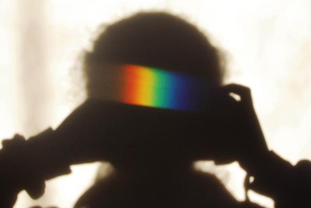 Rainbow colours on a shadow on a wall