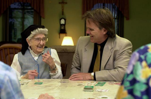 La hermana Esther, de 106 años, riéndose con Snowdon, durante un juego de cartas en el convento.