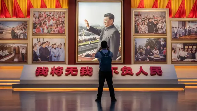 一名参观者在拍摄展览上的习近平照片