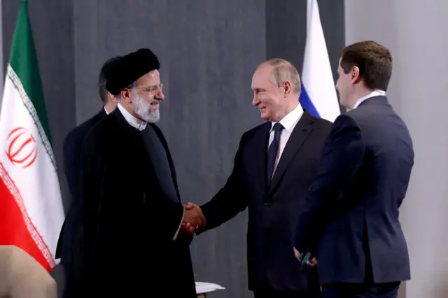 Russian President Vladimir Putin shakes hands with Iranian President Ebrahim Raisi during a meeting on the sidelines of the Shanghai Cooperation Organization (SCO) summit in Samarkand, Uzbekistan, on September 15, 2022.