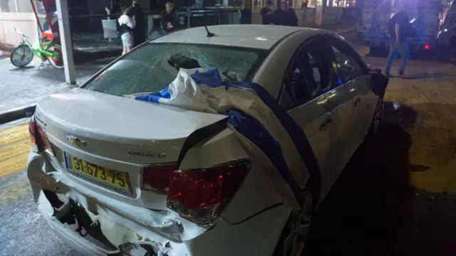 An Israeli flag lies on a damaged car owned by an Israeli-Arab that was attacked and injured by an Israeli Jewish mob on May 12, 2021 in Bat Yam, Israel.