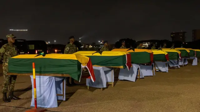 Bodies of di crash victims inside coffin dem cover wit Ghana national colours