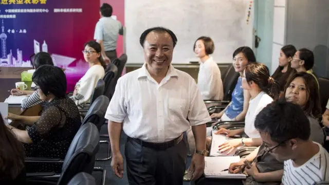 Shu Xin, the head of Weiqing, posing for a photograph in his office in Shanghai