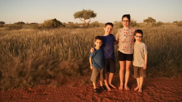 Los cuatro niños posan juntos para una foto.