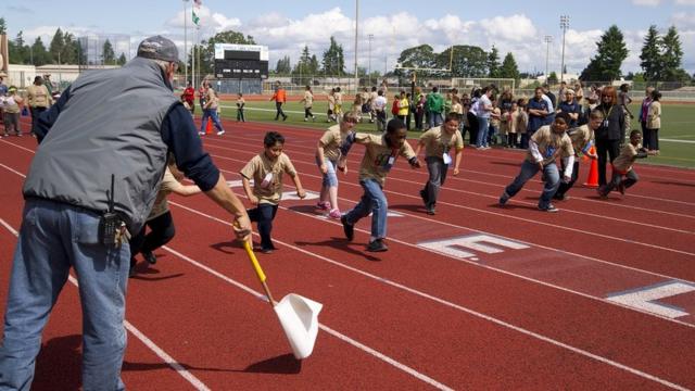 Children taking part in a race on a running track