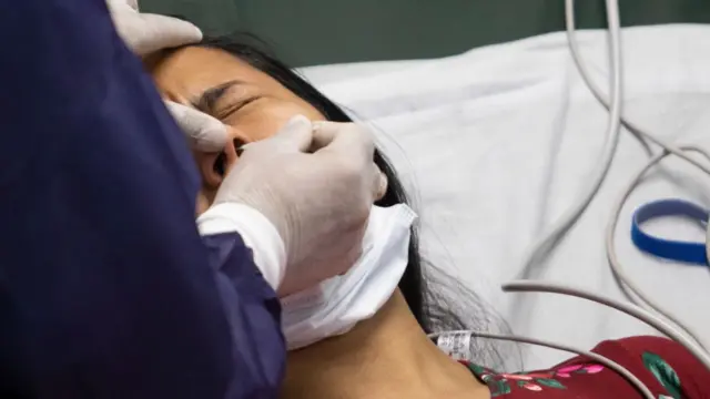 A woman in Venezuela gets tested for coronavirus