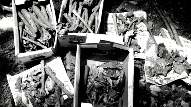Una fotografía en blanco y negro muestra una caja que contiene huesos.