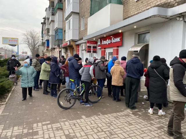 Shoppers queuing to withdraw cash in Kostiantynivka