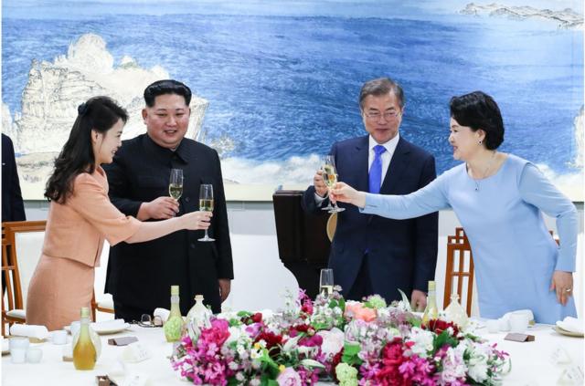North Korea"s leader Kim Jong Un (2nd L) and his wife Ri Sol Ju (L) toast with South Korea"s President Moon Jae-in (2nd R) and his wife Kim Jung-sook (R) during the official dinner at the end of their historic summit at the truce village of Panmunjom on April 27, 2018. The leaders of the two Koreas held a landmark summit on April 27 after a highly symbolic handshake over the Military Demarcation Line that divides their countries, with the North"s Kim Jong Un declaring they were at the "threshold of a new history". / AFP PHOTO / Korea Summit Press Pool / Korea Summit Press PoolKOREA SUMMIT PRESS POOL/AFP/Getty Images