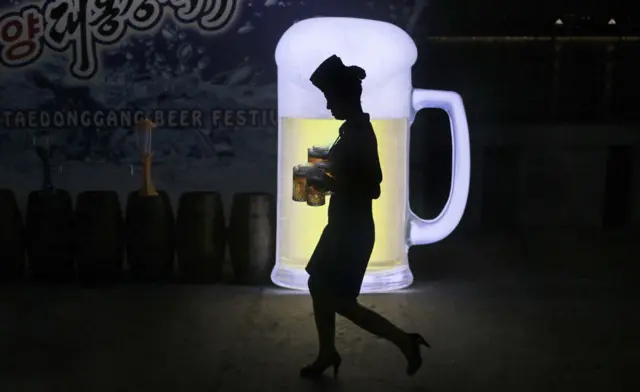 Woman carrying beer at Pyongyang festival