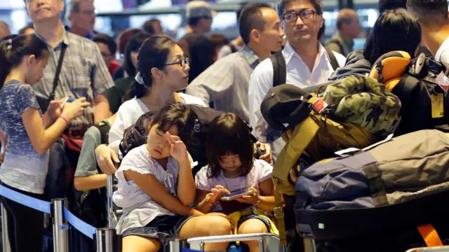 Pasajeros esperando en el aeropuerto de Narita, Tokio