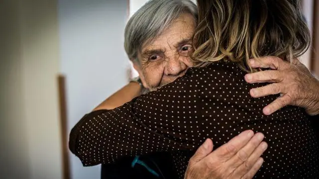 Mãe idosa abraça a filha