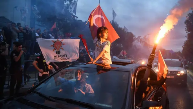 Supporters celebrate outside the AK party headquarters on June 24, 2018 in Istanbul, Turkey