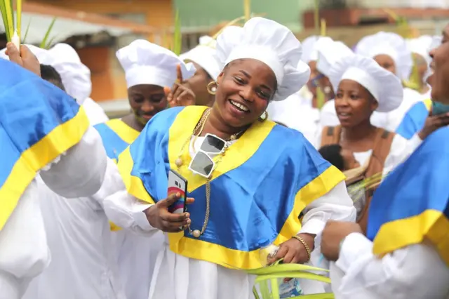 Members of the Celestial Church of Christ International headquarters observe a procession on Palm Sunday, in Lagos, Nigeria, 10 April 2022