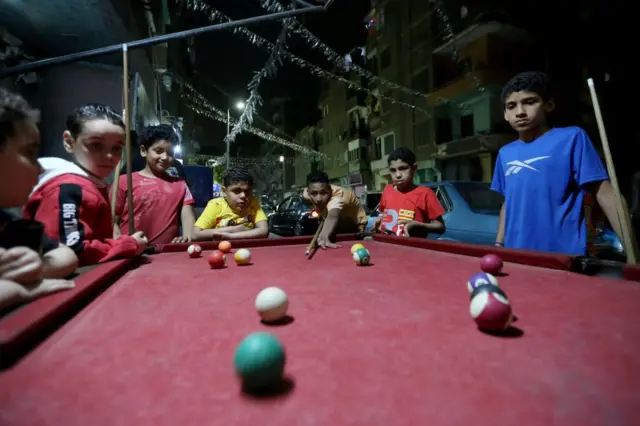 Children play billiards in the Sayeda Zainab district of Cairo.