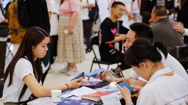 Job seekers and recruiters at a job fair in Beijing, China.