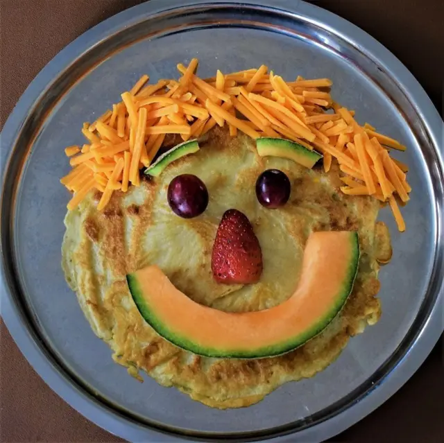Pancake with a face of fruit