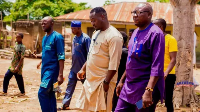 Kunle Adegbite ati awọn ẹmẹwa rẹ n rin kọja lọ ni agboole kan