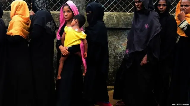 shows Rohingya refugees waiting in line to register at the Kutupalong refugee camp after arriving in Bangladesh.