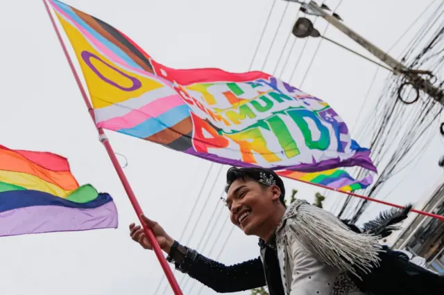PATTAYA, THAILAND - 2023/06/10: Demonstrator seen waving a pride flag during the parade
