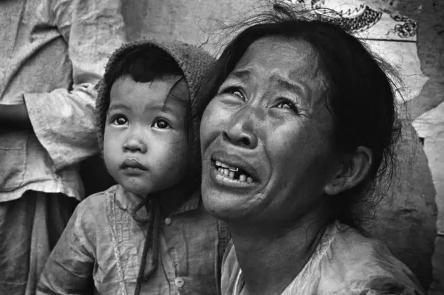 A weeping mother and her young child