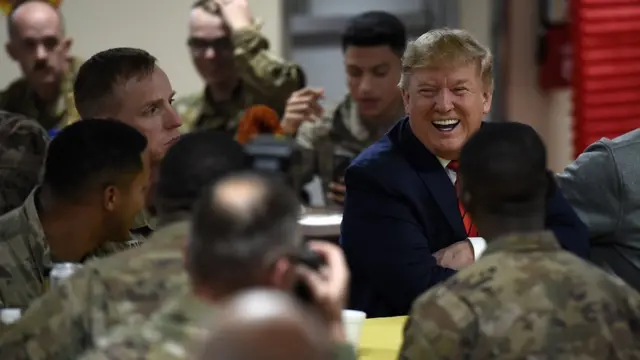 US President Donald Trump sits down for Thanksgiving dinner with US troops at Bagram Air Field