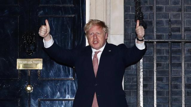 Britain"s Prime Minister Boris Johnson gestures outside 10 Downing Street during the Clap for our carers campaign in support of the NHS, as the spread of the coronavirus disease (COVID-19) continues