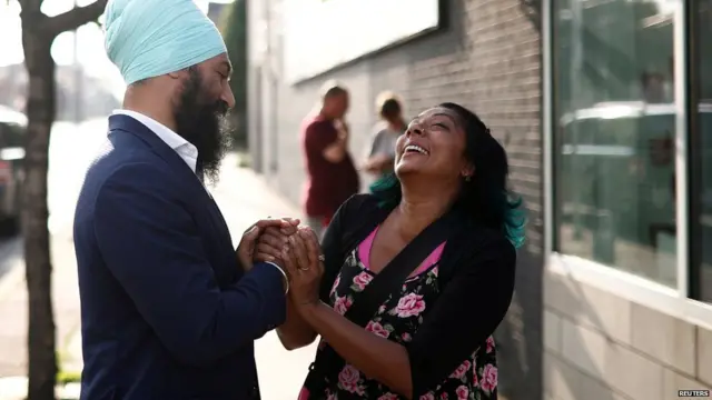 New Democratic Party leadership candidate Singh shakes hands with a woman at a meet and greet event in Hamilton