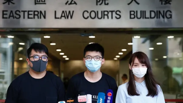 Pro-democracy activists Ivan Lam, Joshua Wong and Agnes Chow arrive at the Eastern Court for a hearing in Hong Kong, China July 6, 2020