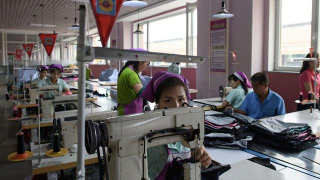 This photo taken on June 12, 2018 shows an employee of the Ryo Won Footwear Factory operating a sewing machine in Pyongyang. US President Donald Trump dangled the carrot of foreign investment in front of North Korean leader Kim Jong Un at their nuclear summit, but analysts say few will want to put money into one of the highest-risk business environments in the world.
