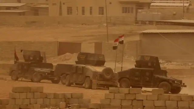 armoured vehicles with Iraqi flags (still from BBC film inside Mosul, 1 November 2011)