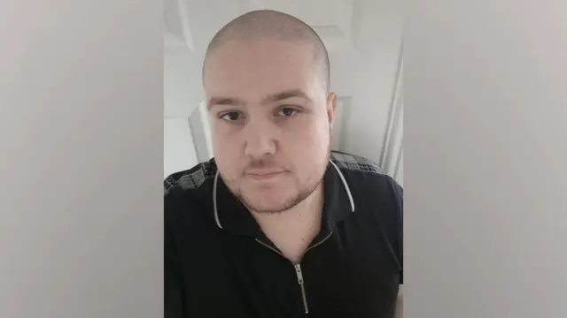 A selfie of Paul Fairbridge. He has a shaved head and a short goatee. He is wearing a black polo shirt.