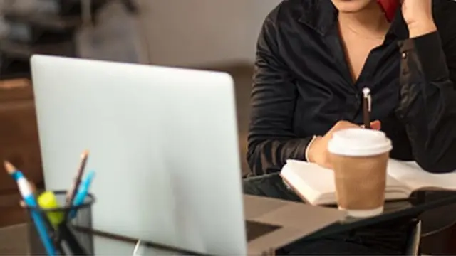 A woman works on a laptop