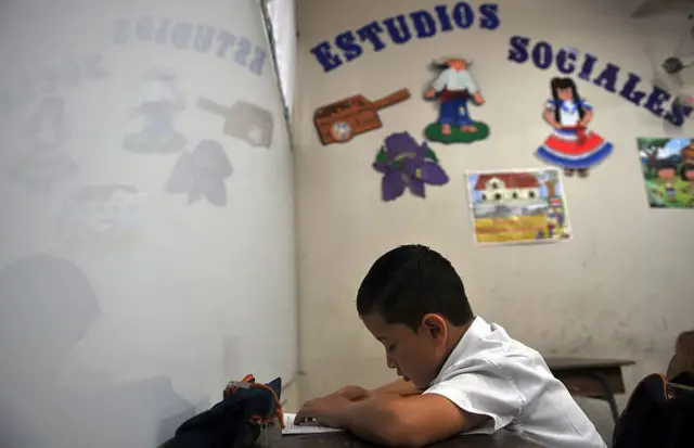 Niño tico estudiando.