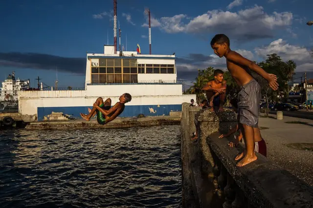 Boys jump into the sea