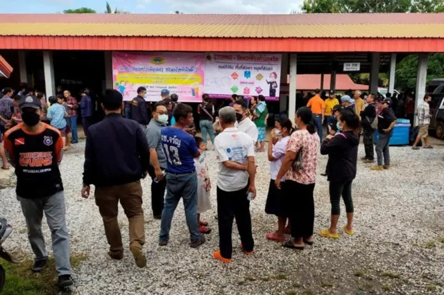 People gather outside of a daycare center"s scene of a mass shooting in the town of Uthai Sawan, 500 km (310 miles) northeast of Bangkok in the province of Nong Bua Lamphu, Thailand October 6, 2022
