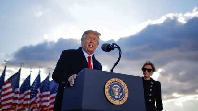 Outgoing US President Donald Trump and First Lady Melania Trump address guests at Joint Base Andrews in Maryland
